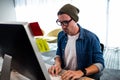 Portrait of serious hipster man working at computer desk Royalty Free Stock Photo