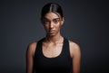 Portrait, serious and Indian woman with fitness, exercise and confident girl against a dark studio background. Face