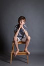 Portrait of serious pensive sad teenager on chair Royalty Free Stock Photo