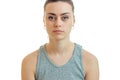 Portrait serious pretty girl in grey t-shirt that looks at camera isolated on a white background Royalty Free Stock Photo