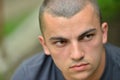 Portrait of serious and sad handsome young man outdoors in nature, looking to a side Royalty Free Stock Photo