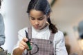 Portrait of serious schoolgirl making robotics