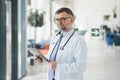 Portrait of serious senior doctor in eyeglasses and in white coat. Royalty Free Stock Photo