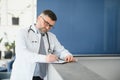 Portrait of serious senior doctor in eyeglasses and in white coat. Royalty Free Stock Photo