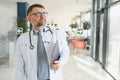 Portrait of serious senior doctor in eyeglasses and in white coat. Royalty Free Stock Photo