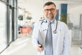 Portrait of serious senior doctor in eyeglasses and in white coat. Royalty Free Stock Photo