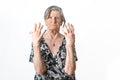 Portrait of serious senior woman showing her deformed hands to the camera because of rheumatoid arthritis. Isolated white Royalty Free Stock Photo