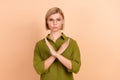 Portrait of serious strick dissatisfied girl with short hair dressed green shirt holding arms crossed  on pastel Royalty Free Stock Photo