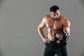 Portrait of a serious strong shirtless male bodybuilder lifting Royalty Free Stock Photo