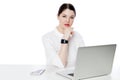 Portrait of serious successful brunette businesswoman in white shirt sitting with laptop, touhing her chin and looking at camera Royalty Free Stock Photo