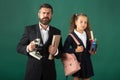 Portrait of serious teacher and pupil school girl ready to school. Portrait of dad and little girls with school supplies Royalty Free Stock Photo