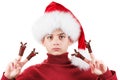 Portrait of serious teen boy in Santa hat with deer toy up isolated on white Royalty Free Stock Photo