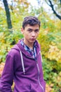 Portrait of a serious teenage boy in an autumn forest Royalty Free Stock Photo