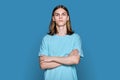 Portrait of serious teenage guy looking at camera on blue background Royalty Free Stock Photo
