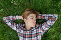 Portrait of serious teenager who lies in grass and rests. Gen Z. Identity development Royalty Free Stock Photo