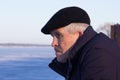 Portrait of serious thoughtful and frowning aged man looking aside in wintertime