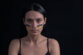 Portrait of serious ukrainian woman with blue and yellow ukrainian flag on her cheek.The symbol of the inviolability of the