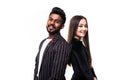 Portrait of a serious young asian couple dressed in formal wear standing back to back over white background Royalty Free Stock Photo