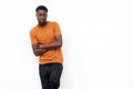 Serious young black man in t shirt posing against isolated white background with arms crossed Royalty Free Stock Photo