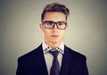 Portrait of a serious young business man on gray background Royalty Free Stock Photo