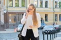 Portrait of serious young business woman talking on mobile phone Royalty Free Stock Photo