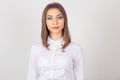 Portrait serious young business woman wearing white shirt, looking to you camera, isolated white background. One single person. Royalty Free Stock Photo