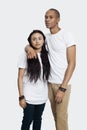 Portrait of serious young couple in casuals standing against white background Royalty Free Stock Photo