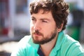 Portrait of serious young man resting in coffee shop