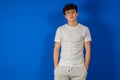 Portrait Of A Serious Young Man Standing On Blue Background Royalty Free Stock Photo