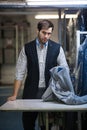 Portrait of a serious young tailor man at the store