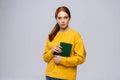 Portrait of serious young woman college student holding books and looking at camera, Royalty Free Stock Photo