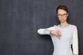 Portrait of serious young woman giving thumb down sign of disapproval Royalty Free Stock Photo