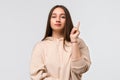 Portrait of Serious young woman with long chestnut hair showing index finger, scolding or telling off someone Royalty Free Stock Photo