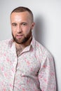 Confident looking business man in flamboyant shirt walks down a staircase