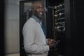 Portrait, server room and IT black man on tablet for database connection cable, maintenance or software update