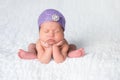 Newborn Baby Girl Wearing a Lavender Flapper Hat Royalty Free Stock Photo