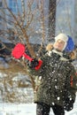 Portrait of seven year old caucasian happy boy playing with first winter snow Royalty Free Stock Photo