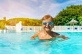 Boy with swimming goggles standing in outdoor pool Royalty Free Stock Photo