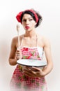 Portrait of attractive pinup girl holding bowl and spoon & looking at camera curious on white or light copy space Royalty Free Stock Photo