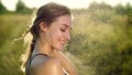 Portrait of a sexy, beautiful young blonde girl, under a light summer rain, in the sun rays, on a green meadow. The girl Royalty Free Stock Photo