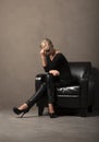 Portrait of blonde woman seated in chair Royalty Free Stock Photo
