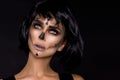 Portrait brunette woman in Halloween makeup on a black background in the studio. Make-up skeleton, monster and witch Royalty Free Stock Photo
