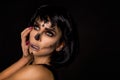 Portrait brunette woman in Halloween makeup on a black background in the studio. Make-up skeleton, monster and witch Royalty Free Stock Photo