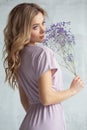 Portrait of a sexy charming woman in a white blouse with a flower in her hands