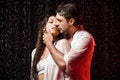 portrait of sexy couple in white shirts standing under rain