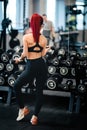 Portrait of sexy fit woman working out with dumbbells in the gym Royalty Free Stock Photo