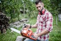 Portrait of and hansome man with chainsaw