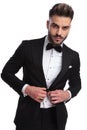 Portrait of a man buttoning his tuxedo Royalty Free Stock Photo