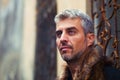 Portrait of a man in wolf fur and ornamental medieval window on background