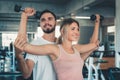 Portrait of woman in fitness gym training with dumbbell equipment., Couple caucasian are working out and training together in